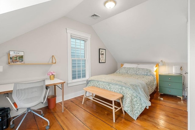 bedroom featuring lofted ceiling and wood-type flooring