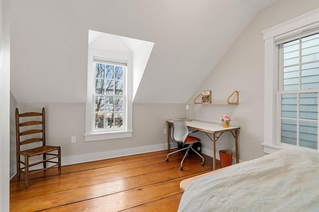 bedroom with hardwood / wood-style flooring and lofted ceiling