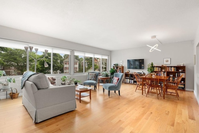 22 Chestnut Pl Unit 111, Brookline, MA 02445 - living area featuring light wood-type flooring and a chandelier