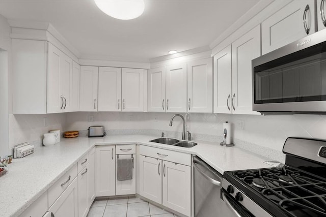 22 Chestnut Pl Unit 111, Brookline, MA 02445 - kitchen with appliances with stainless steel finishes, white cabinetry, and light countertops