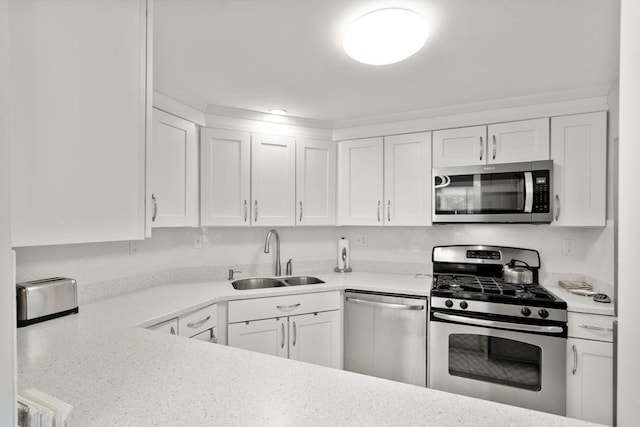 22 Chestnut Pl Unit 111, Brookline, MA 02445 - kitchen with stainless steel appliances, light countertops, and white cabinets