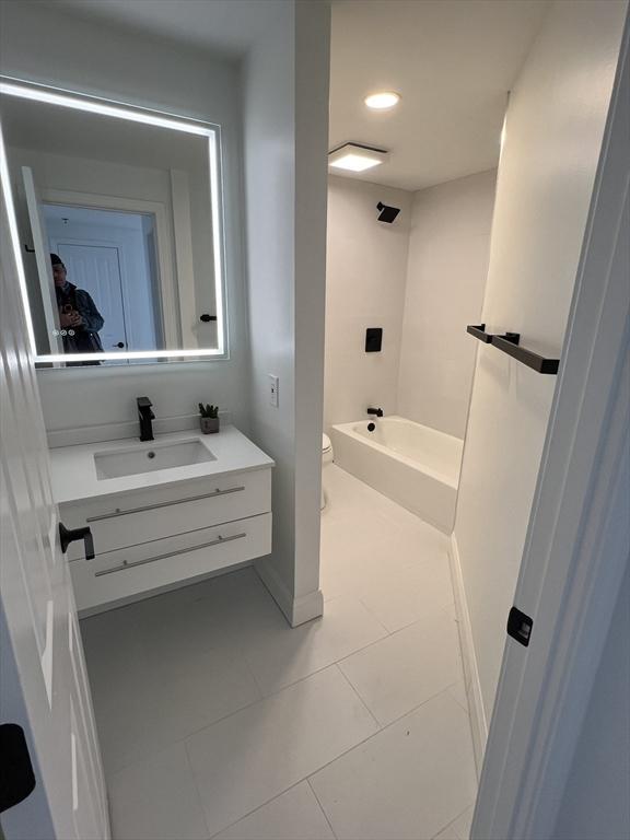 bathroom featuring tile patterned floors, toilet, recessed lighting, shower / bathing tub combination, and vanity