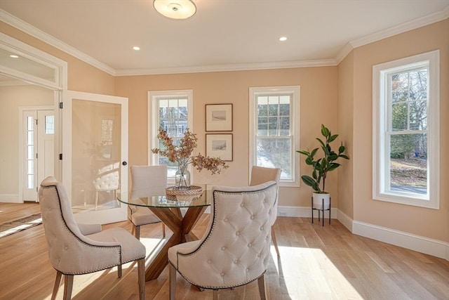 dining room featuring ornamental molding and light wood-type flooring