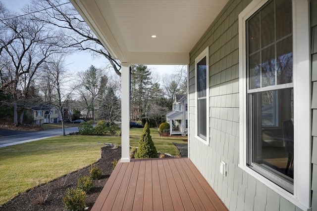 wooden terrace featuring a yard