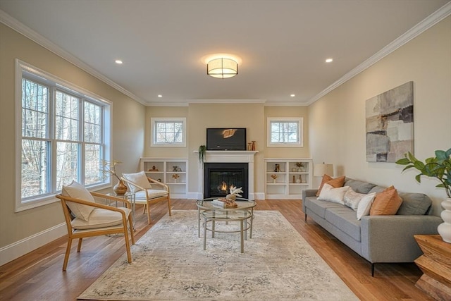 living room featuring light wood-type flooring and ornamental molding