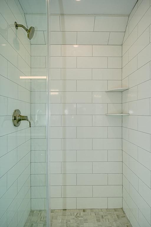 bathroom with a tile shower