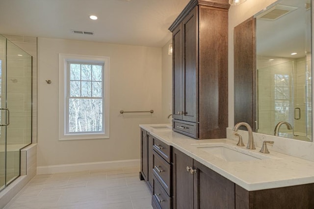 bathroom featuring vanity and a shower with door