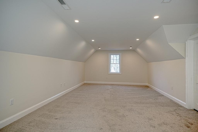 bonus room featuring light colored carpet and vaulted ceiling