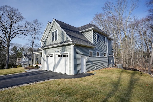 view of property exterior with central air condition unit, a lawn, and a garage