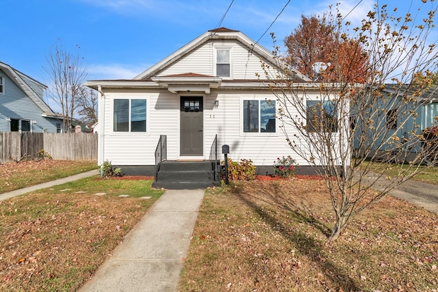 bungalow-style home with a front lawn