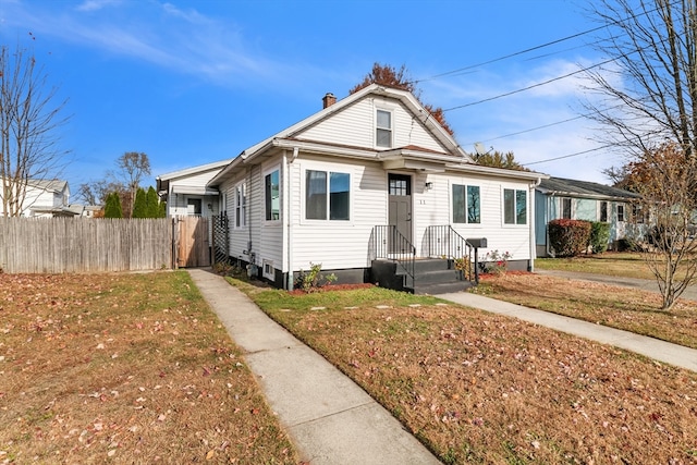 bungalow-style house with a front yard