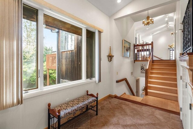 16 Wadsworth Ln, Dartmouth, MA 02748 - stairway featuring plenty of natural light, a chandelier, vaulted ceiling, tile patterned floors, and baseboards