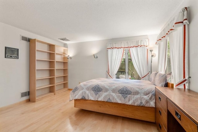 16 Wadsworth Ln, Dartmouth, MA 02748 - bedroom with light wood finished floors and a textured ceiling