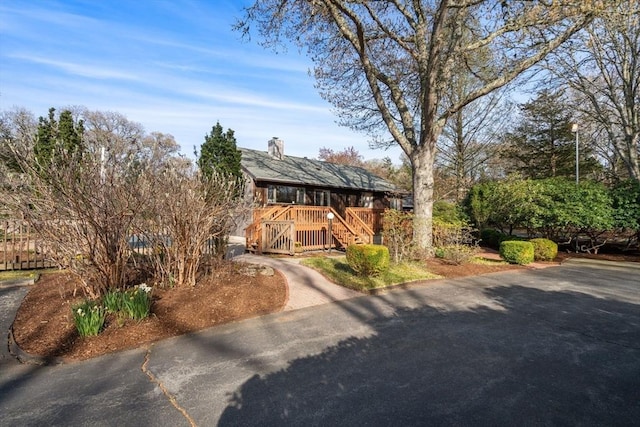 16 Wadsworth Ln, Dartmouth, MA 02748 - chalet / cabin with asphalt driveway, a wooden deck, a chimney, and stairway