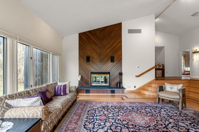16 Wadsworth Ln, Dartmouth, MA 02748 - living room featuring high vaulted ceiling, wood finished floors, and a glass covered fireplace