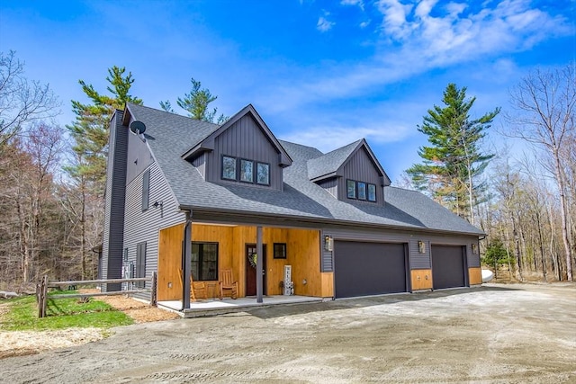 56 Otis-Tolland Rd, Blandford, MA 01008 - view of front of property with covered porch, driveway, an attached garage, and roof with shingles