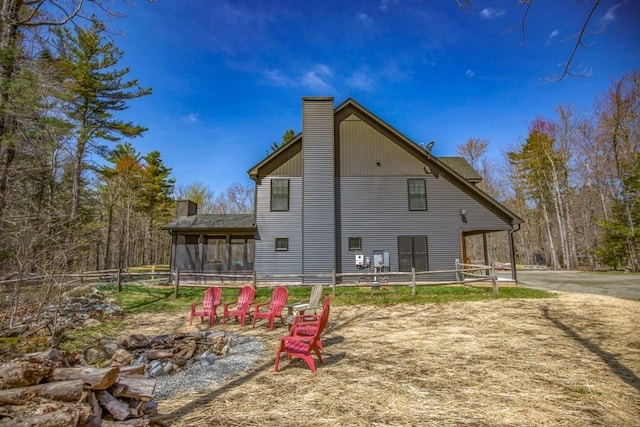 56 Otis-Tolland Rd, Blandford, MA 01008 - rear view of property featuring a chimney, a sunroom, and a fire pit