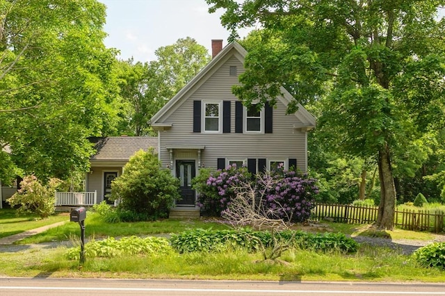 661 Main St, Hanson, MA 02341 - view of front of house featuring a chimney and view of scattered trees