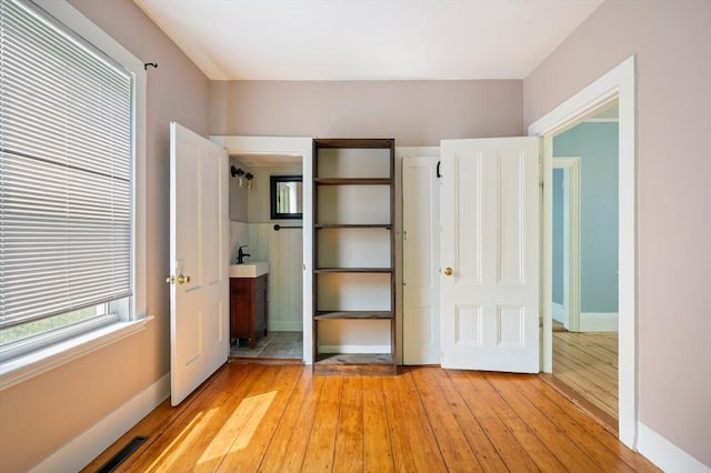 661 Main St, Hanson, MA 02341 - unfurnished bedroom with light wood-style floors and baseboards