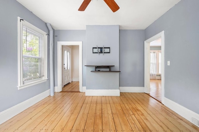661 Main St, Hanson, MA 02341 - unfurnished living room featuring a ceiling fan and hardwood / wood-style floors