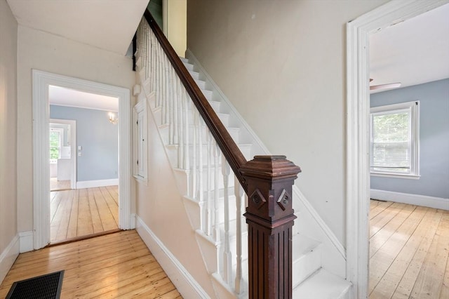 661 Main St, Hanson, MA 02341 - stairway featuring hardwood / wood-style floors, healthy amount of natural light, and a chandelier