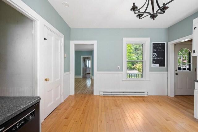 661 Main St, Hanson, MA 02341 - foyer with a baseboard radiator, a wainscoted wall, light wood-style flooring, and a chandelier