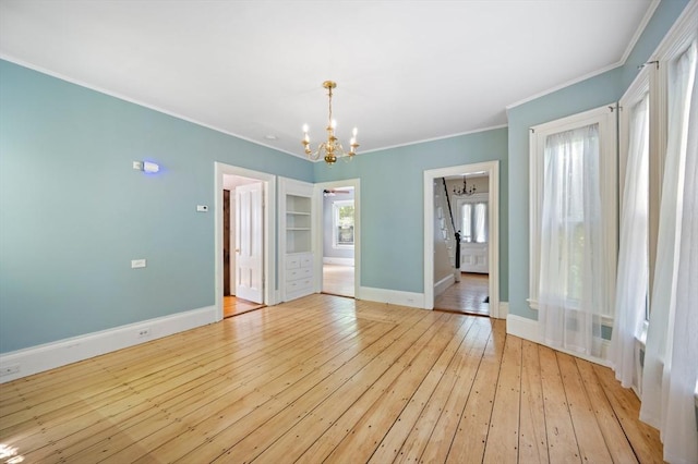 661 Main St, Hanson, MA 02341 - unfurnished room with a chandelier, crown molding, and light wood-style flooring