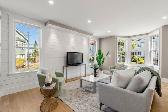 110 Fayette Unit 110, Watertown, MA 02472 - living room with wood finished floors, wooden walls, baseboards, and recessed lighting