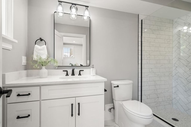 110 Fayette Unit 110, Watertown, MA 02472 - bathroom featuring toilet, vanity, marble finish floor, and a tile shower