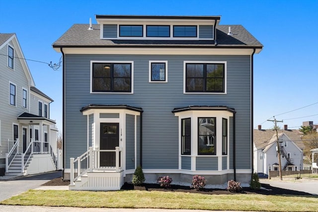 110 Fayette Unit 110, Watertown, MA 02472 - view of front facade featuring a front yard and roof with shingles