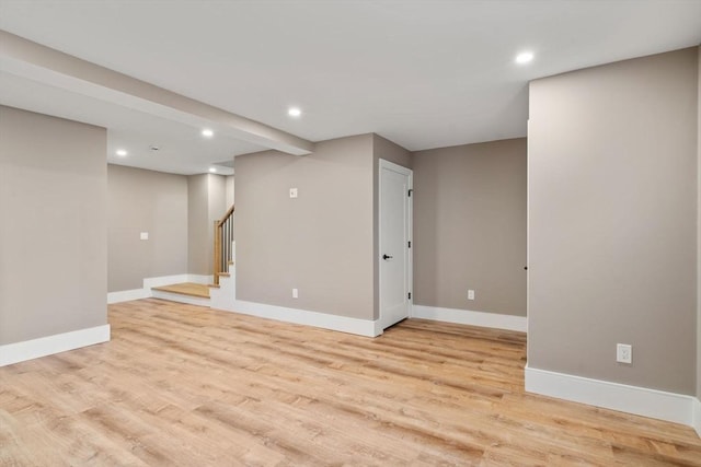 110 Fayette Unit 110, Watertown, MA 02472 - basement featuring baseboards, recessed lighting, light wood-style floors, and stairs