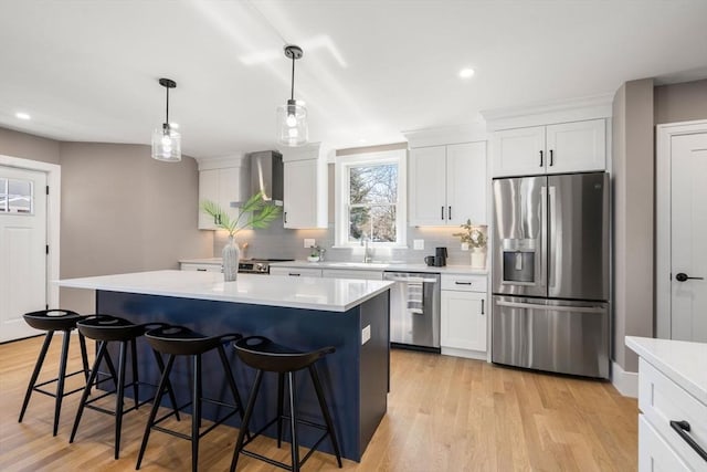110 Fayette Unit 110, Watertown, MA 02472 - kitchen with tasteful backsplash, a center island, wall chimney exhaust hood, stainless steel appliances, and a breakfast bar area