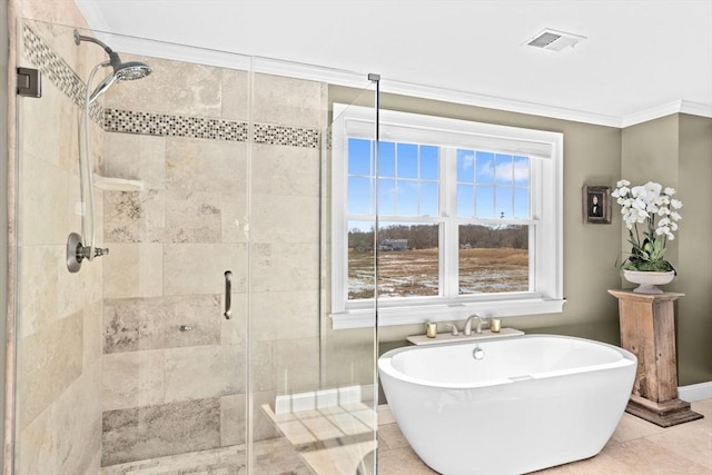 bathroom with visible vents, a freestanding bath, ornamental molding, a stall shower, and tile patterned floors