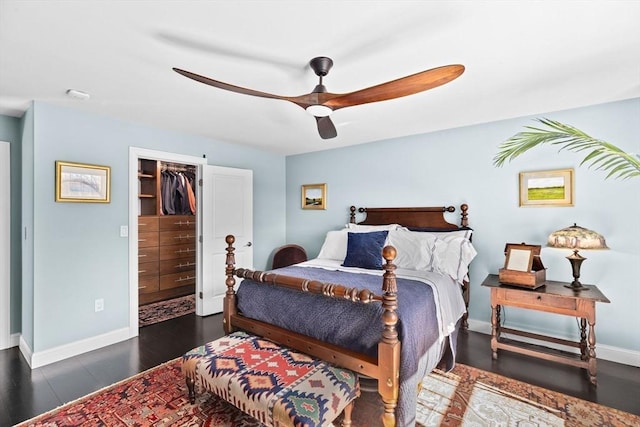 bedroom featuring wood finished floors, baseboards, a closet, and ceiling fan