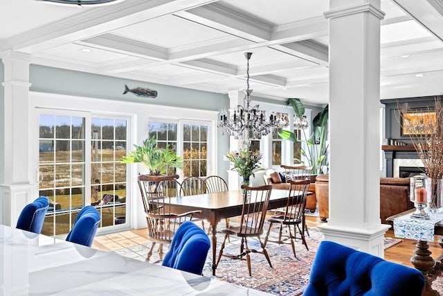 dining space featuring beam ceiling, decorative columns, and coffered ceiling