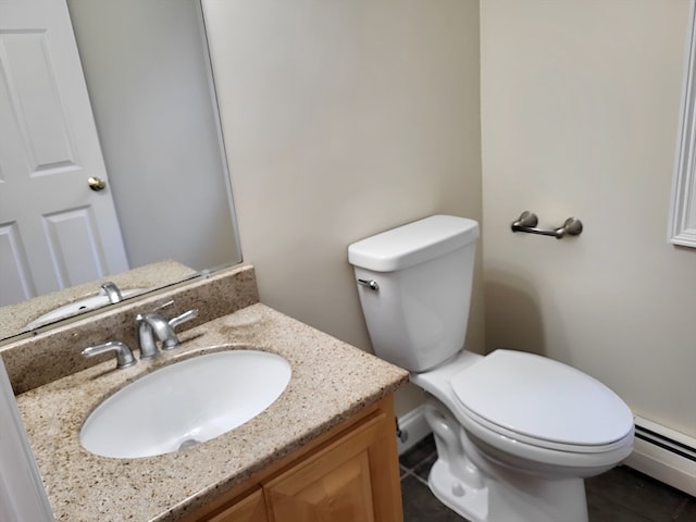 bathroom featuring vanity, toilet, a baseboard radiator, and tile patterned floors