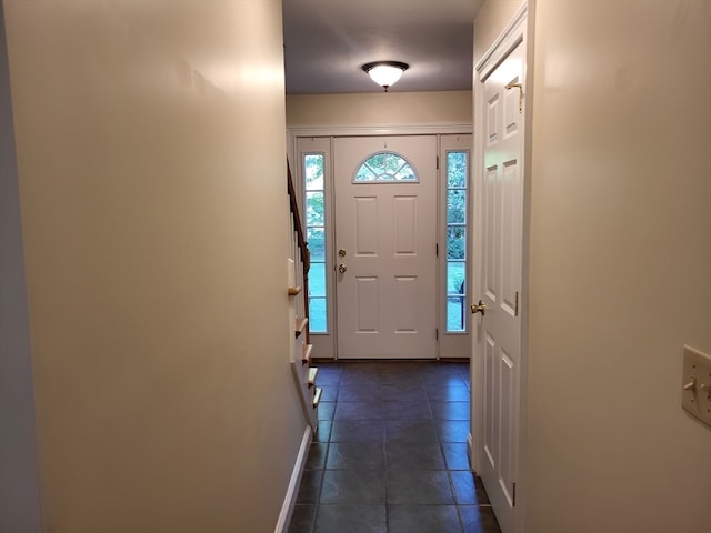 foyer entrance with dark tile patterned floors