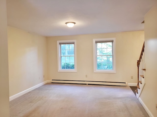 empty room with light carpet and baseboard heating