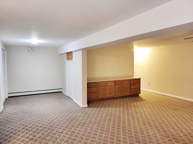 basement with a baseboard heating unit and light carpet