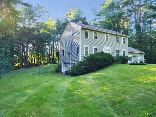 exterior space with cooling unit and a front lawn