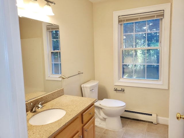 bathroom with a baseboard heating unit, tile patterned flooring, toilet, and vanity