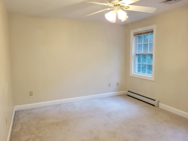 carpeted empty room featuring a baseboard heating unit and ceiling fan