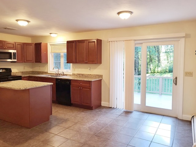 kitchen with black appliances, light tile patterned floors, sink, and light stone countertops