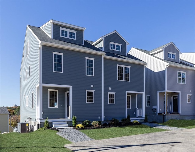 view of front of home featuring a front lawn and central air condition unit