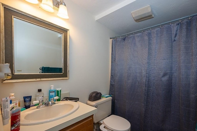 bathroom featuring vanity and toilet