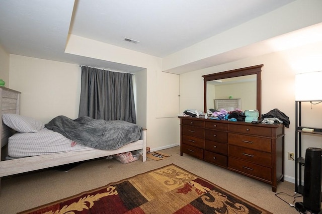 bedroom featuring light colored carpet and baseboards