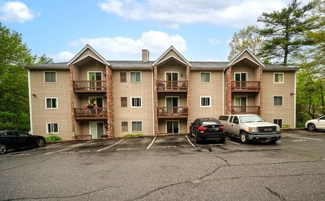 view of property with uncovered parking