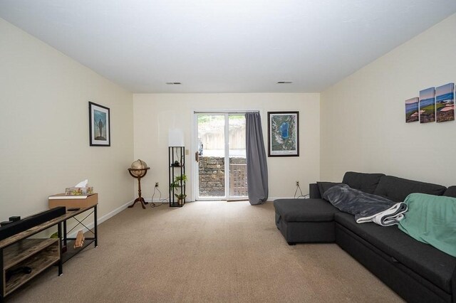 living room with carpet flooring and baseboards
