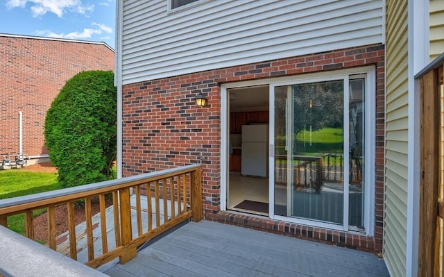 90 Roper St Unit G, Lowell, MA 01852 - view of exterior entry with brick siding and a wooden deck
