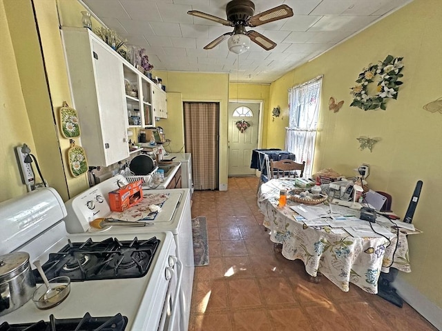 kitchen featuring white range with gas stovetop, ceiling fan, and open shelves